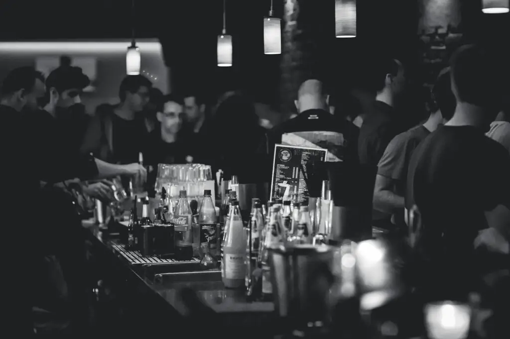 grayscale photography of bottles on top of table