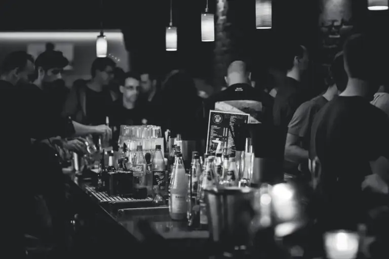 grayscale photography of bottles on top of table